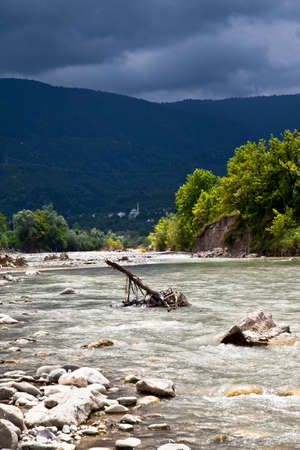 Calmly flowing, clean and crystal clear river, river in forest and big mountainsの写真素材