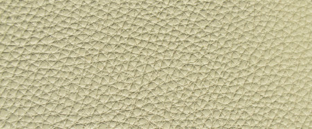 Imitation cowhide beige texture close up, useful as background for any design work