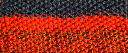 Pattern fabric made of wool. Handmade knitted fabric colored wool background texture