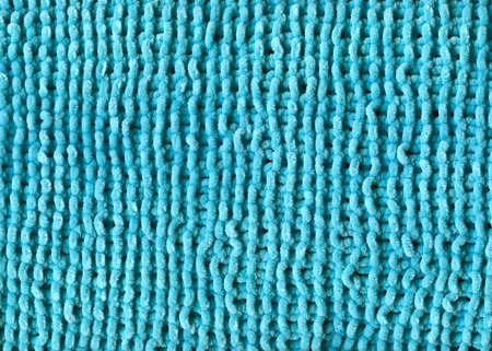 Pattern fabric made of wool. Handmade knitted fabric turquoise wool background texture