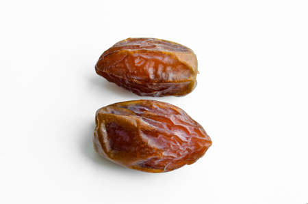 Organic fresh nutritious dried dates dates medjool grains, isolated on white background