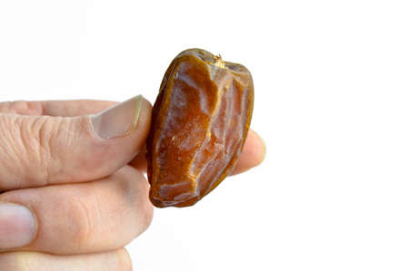 Organic fresh nutritious dried dates dates medjool grains, isolated on hand