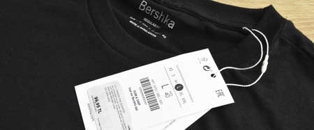 New black Bershka L t-shirt and blank label, on wooden floor, may 01 2022 Istanbul Maltepe Turkiye...