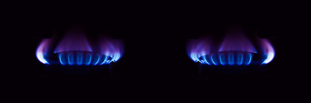 Gas stove burning in the kitchen, blue flames isolated on black backgroundの写真素材