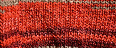 Pattern fabric made of wool. Handmade knitted fabric red wool background texture