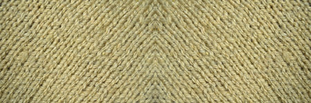 Pattern fabric made of wool. Handmade knitted fabric beige wool background textureの写真素材