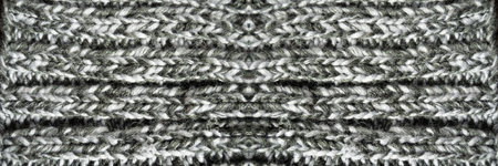 Pattern fabric made of wool. Handmade knitted fabric gray wool background texture
