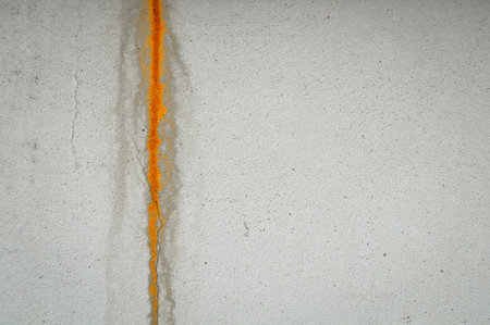 Rust stain on plaster on beige and white concrete wall, rough wall plaster, rough wall plasterの写真素材