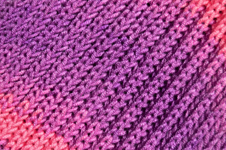 Pattern fabric made of wool. Handmade knitted fabric purple and pink wool background textureの写真素材