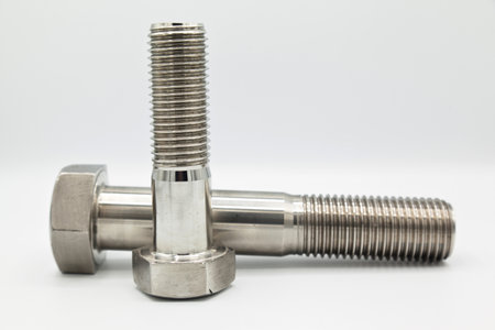 Stainless steel metal with metric A4 bolts, industrial machined metal part, isolated on white...