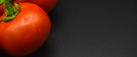 Fresh tasty tomato, all organic tomato, fresh red organic tomato, isolated on black backgroundの写真素材