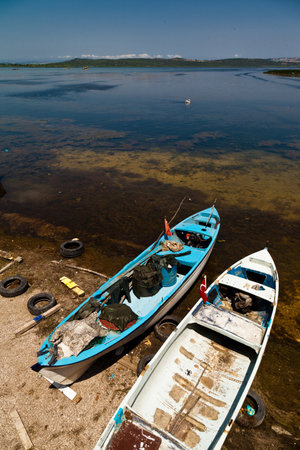 Wooden fishing boats waiting by Ulubat or Uluabat Lake in Bursa, Turkey, June 25 2023のeditorial素材