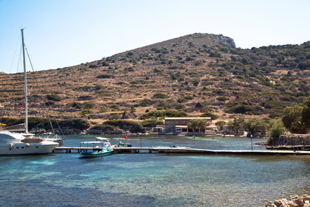 Yachts and ships from various countries are on vacation in the natural harbor area of the Ancient City of Knidos. Turkey Mugla Datca, June 28 2023のeditorial素材