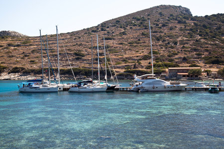 Yachts and ships from various countries are on vacation in the natural harbor area of the Ancient City of Knidos. Turkey Mugla Datca, June 28 2023のeditorial素材