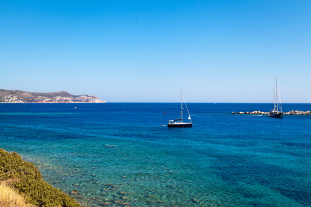 Yachts and ships from various countries are on vacation in the natural harbor area of the Ancient City of Knidos. Turkey Mugla Datca, June 28 2023のeditorial素材