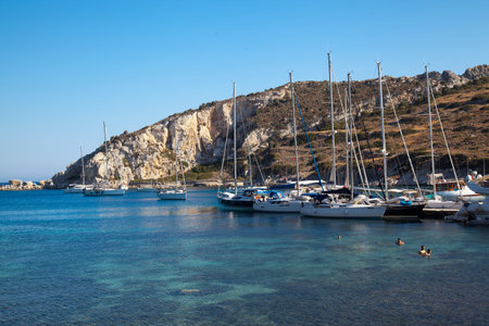 Yachts and ships from various countries are on vacation in the natural harbor area of the Ancient City of Knidos. Turkey Mugla Datca, June 28 2023のeditorial素材