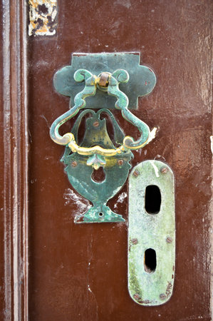 Decorative vintage old fashioned metal door knocker and keyhole, antique brown door handles Istanbul...