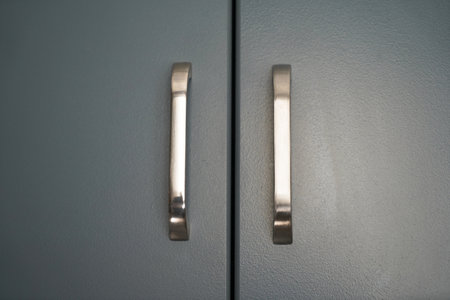 gray lacquered kitchen cabinet and chrome stainless handle detail, luxury kitchen equipmentの写真素材