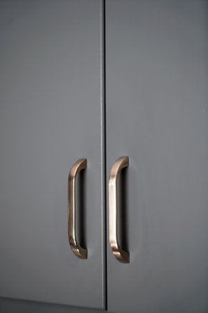 gray lacquered kitchen cabinet and chrome stainless handle detail, luxury kitchen equipmentの写真素材