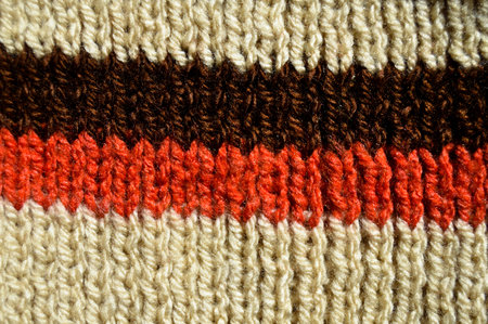 Pattern fabric made of wool. Handmade knitted fabric brown red and beige wool background textureの写真素材