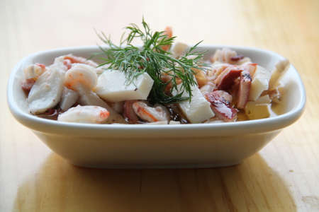 carefully prepared fish products and appetizers on wooden table