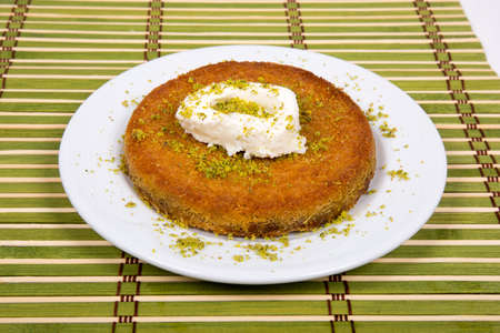 Turkish dessert with pistachio cream and cream, kÃ¼nefe, green backgroundの写真素材