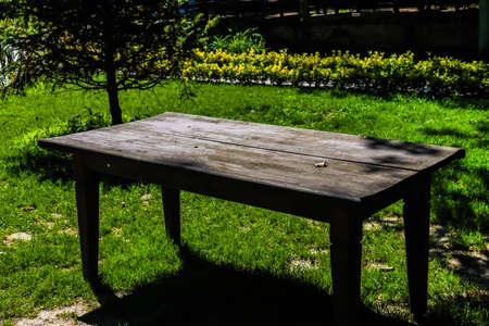Wooden table in the garden on a sunny day. High quality photoの写真素材