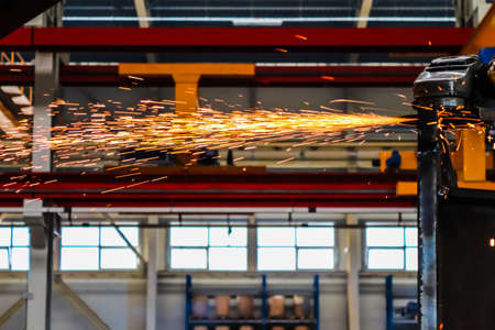 Industrial metal cutting with sparks in a factory. High quality photo