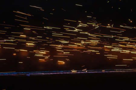 Sparks from welding robots movement in a car factory. Industrial backgroundの写真素材