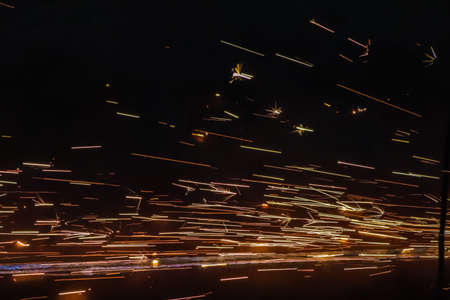 Sparks from welding on the street at night. High quality photoの写真素材
