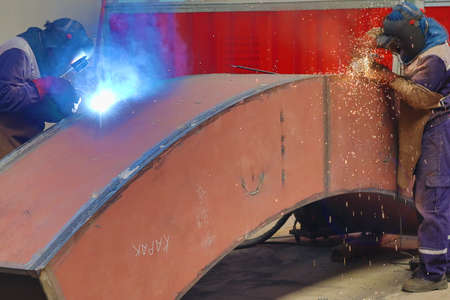 Welder at work in the workshop. Welding of steel.