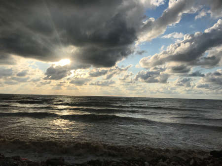 Sunset on the Baltic Sea with dramatic clouds and stormy skies.