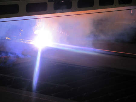 Welding of steel structure with sparks from a welding machine.