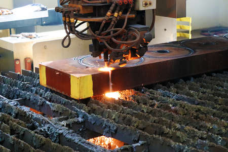 Industrial laser cutting metal in a metallurgical plant, close-up