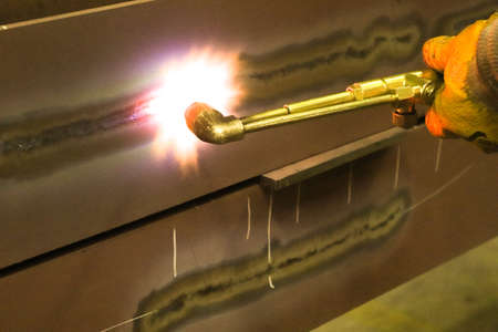 Welding of metal parts with a torch. Welding work.