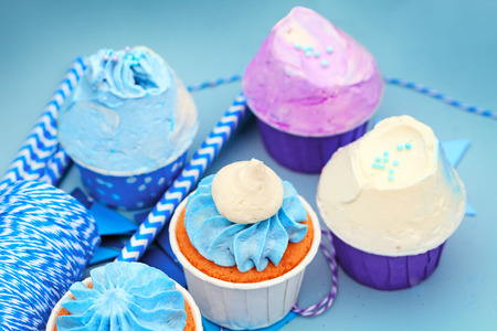 Delicious sweet buffet with cupcakes on blue backgroundの写真素材