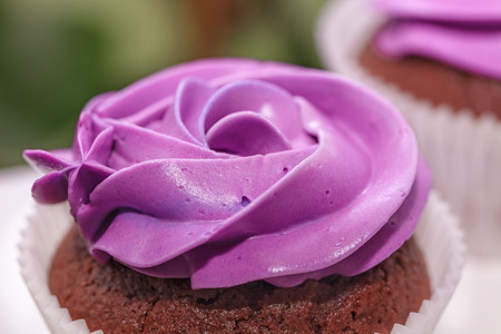 Delicious sweet buffet with cupcakes topped with roseの写真素材