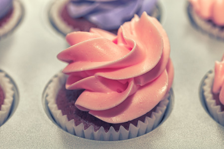 Delicious sweet buffet with cupcakes topped with roseの写真素材