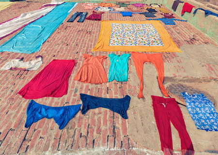 streets of holy Varanasi, traditional colorful clothing dried in the sun, India