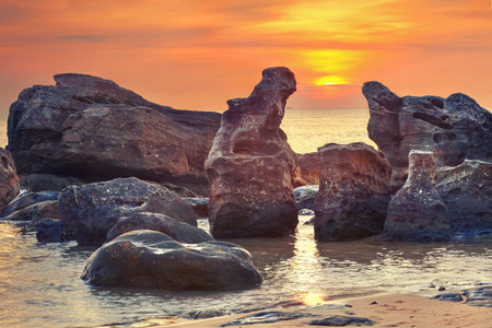 Vivid sunset amongst  fantastic rocks in  the oceanの写真素材