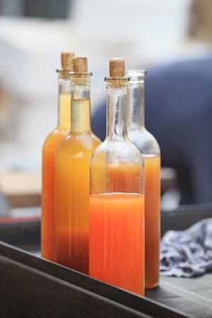 colourful drink in whine bottles with corkの写真素材