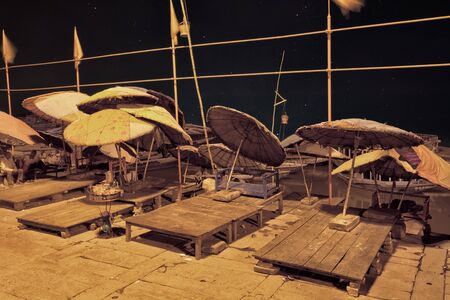 Night view of holy ghats of Varanasi. Umprellas and beds on ghatの写真素材