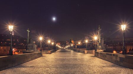 Prague Charles bridge glowing at starry nightのeditorial素材