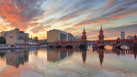 Berlin, Germany, - August 30, 2015: Sun rising over Spree river and Oberbaum Bridge at Friedrichshain-Kreuzberg borough of Berlinのeditorial素材