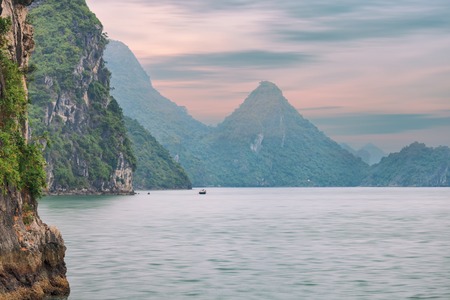 Dreamy sunset among the rocks of Halong Bay, Vietnamの写真素材