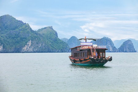 Halong Bay, Vietnam, cruise boat sailing among the rocks of Cat Ba islandの写真素材