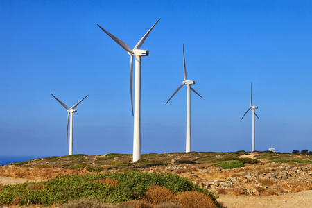 Crete island, Greece: windsmills in mountains over the sea