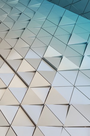Abstract close-up view of modern aluminum ventilated facade of triangles