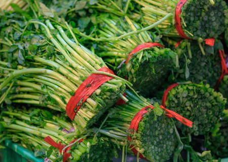 Traditional asian market with fresh exotic vegetables and herbs