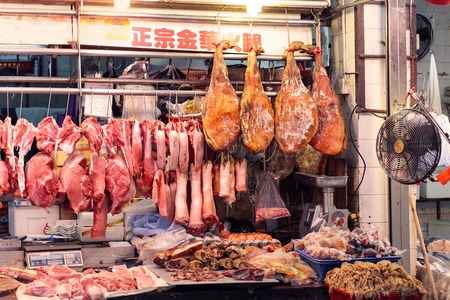 Hong Kong Special Administrative Region of the People's Republic of China - April 19, 2016: Traditional asian market butcher shop selling raw meatのeditorial素材